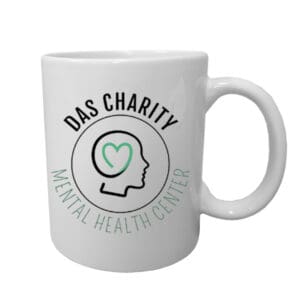 A white mug with the words das charity mental health center on it.