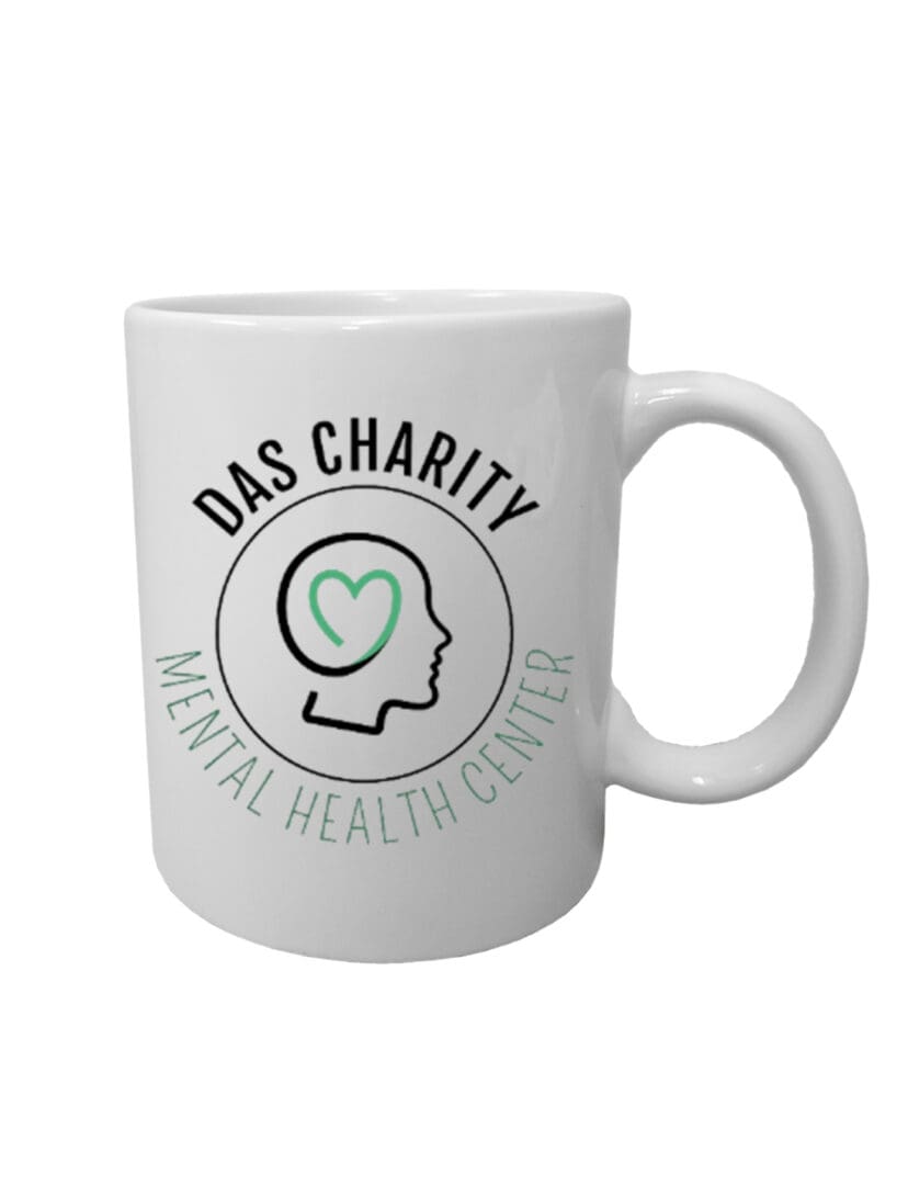 A white mug with the words das charity mental health center on it.